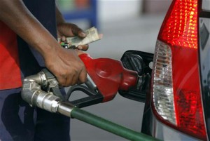 An employee fills a vehicle with petrol at a fuel station in New Delhi