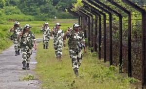 Female personnel of India's Border Security Force patrol along the fencing of the India-Bangladesh international border ahead of India's Independence Day celebrations, at Dhanpur village in Tripura