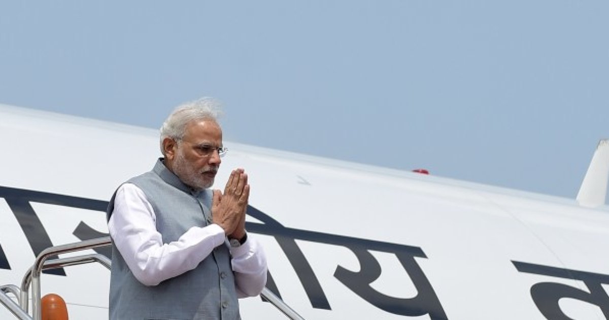 Indian Prime Minister, Narendra Modi gestures as he disembarks from the plane on his arrival at the Hazrat Shahjalal International Airport in Dhaka on June 6, 2015.  India's prime minister arrived in Bangladesh to seal a land pact which will finally allow tens of thousands of people living in border enclaves to choose their nationality after decades of stateless limbo.  AFP PHOTO/ Munir uz ZAMAN        (Photo credit should read MUNIR UZ ZAMAN/AFP/Getty Images)