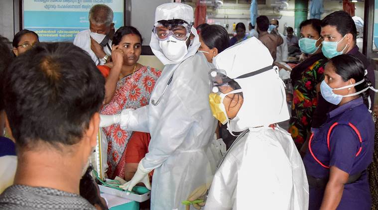Kozhikode: Family members of the patients admitted at the Kozhikode Medical College wear safety masks as a precautionary measure after the 'Nipah' virus outbreak, in Kozhikode, on Monday. (PTI Photo)(PTI5_21_2018_000184B)