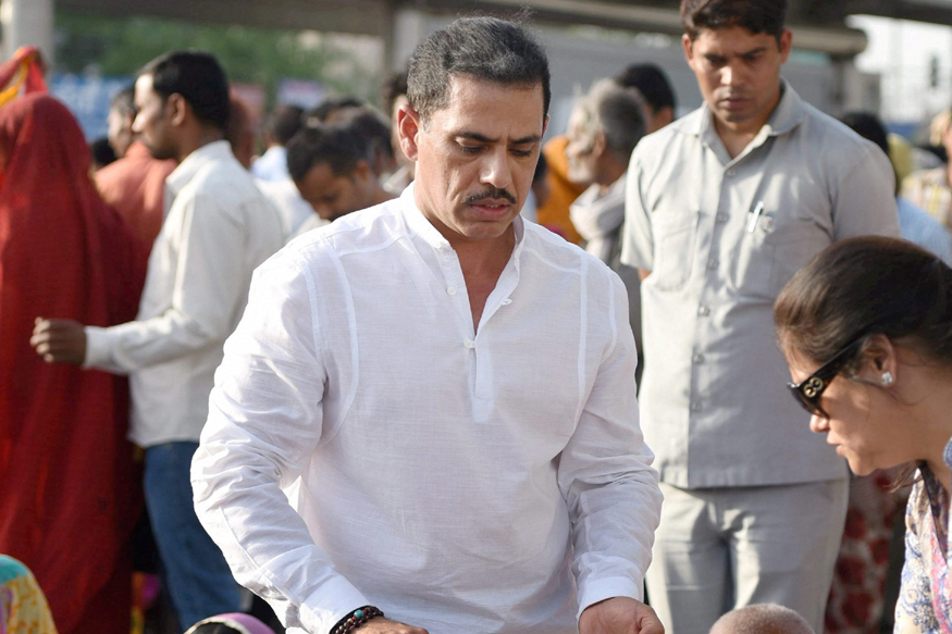 New Delhi: Robert Vadra serves food to underprivileged people outside the AIIMS in New Delhi on Tuesday. PTI Photo by Vijay Verma    (PTI4_11_2017_000170B)
