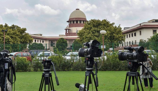 **EDS PLEASE NOTE: RPT WITH DAY CORRECTION** New Delhi: Lensmen at the Supreme Court, in New Delhi on Tuesday, July 17, 2018. The apex court on Tuesday asked Parliament to consider enacting a new law to effectively deal with incidents of mob lynching. (PTI Photo/Manvender Vashist)  (PTI7_17_2018_000034B)
