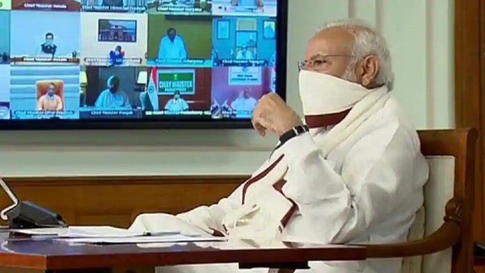 PM-Narendra-Modi-sets-an-example-wearing-a-homemade-mask-in-CM-meeting-696x392